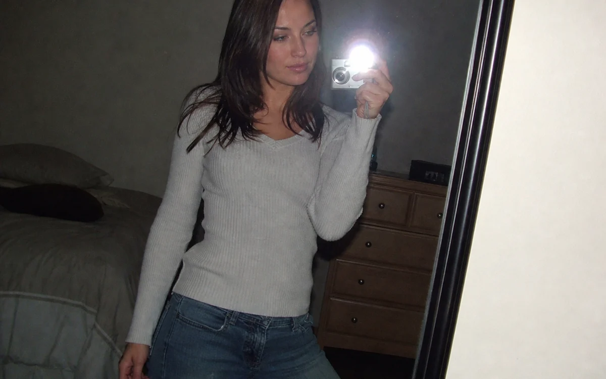 Y2K Mirror Selfie: A crisp mirror reflection with direct flash bloom and cool digicam color.